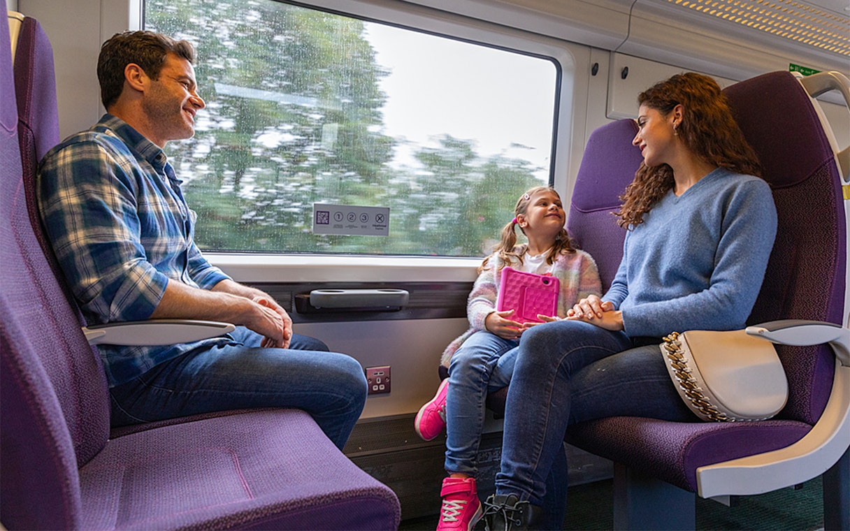 Family enjoying a ride on the Heathrow Express train to London Paddington.