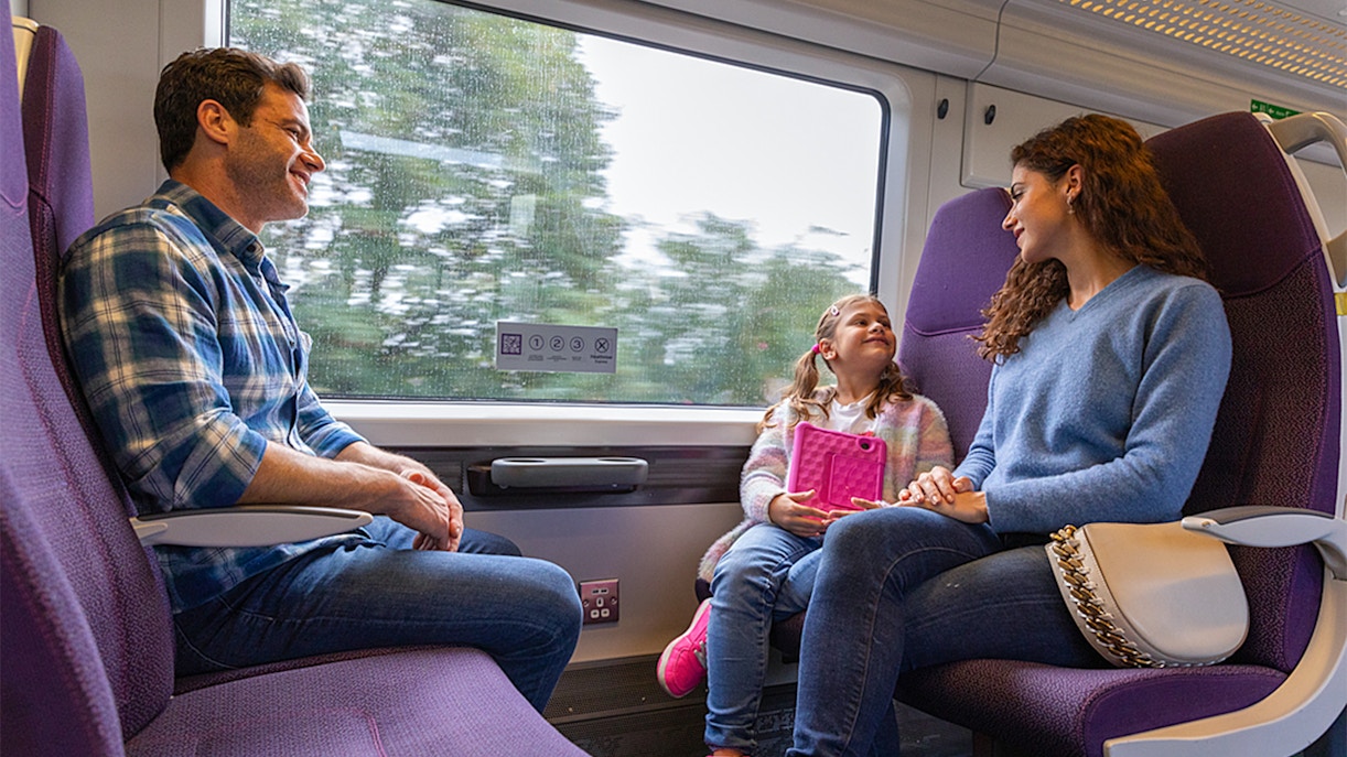 Family enjoying a ride on the Heathrow Express train to London Paddington.