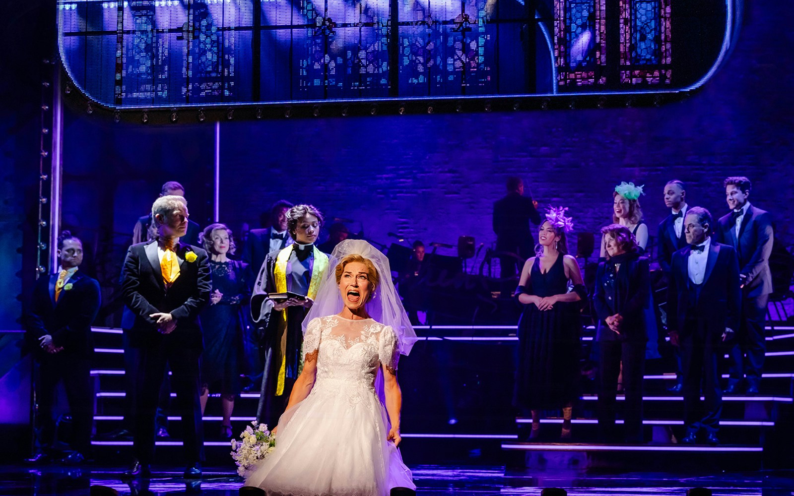 Cast performing Stephen Sondheim's Old Friends on stage with a bride in the foreground.
