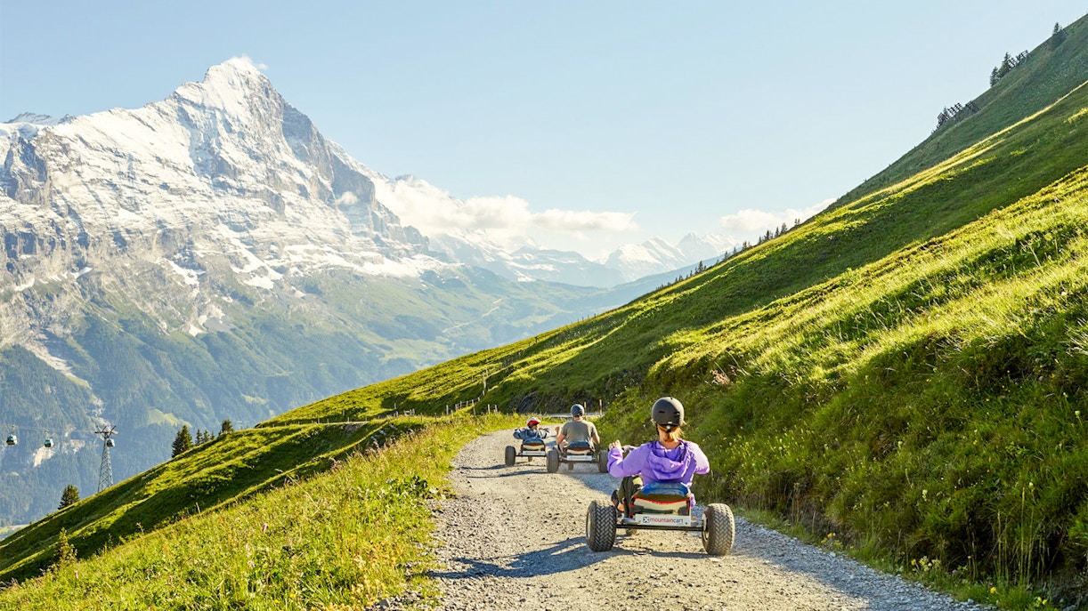 Grindelwald First Mountain Cart ride with scenic alpine views in Switzerland.
