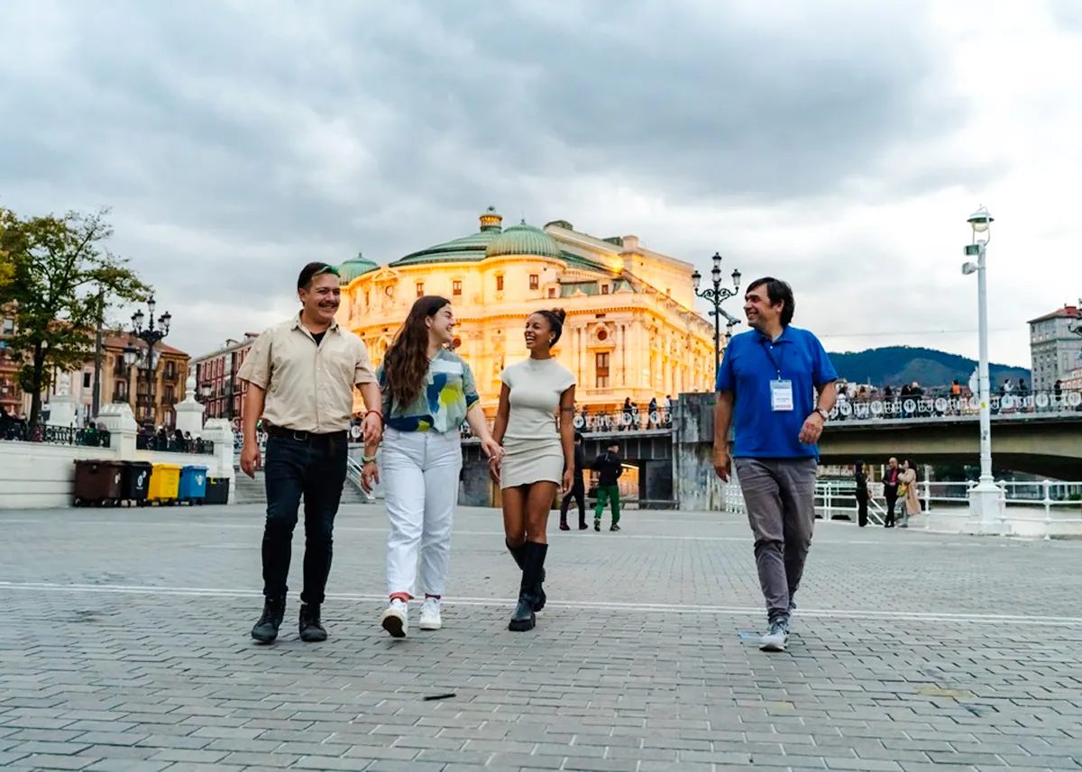 Group walking near Bilbao's Arriaga Theater during Guggenheim and Gaztelugatxe tour.