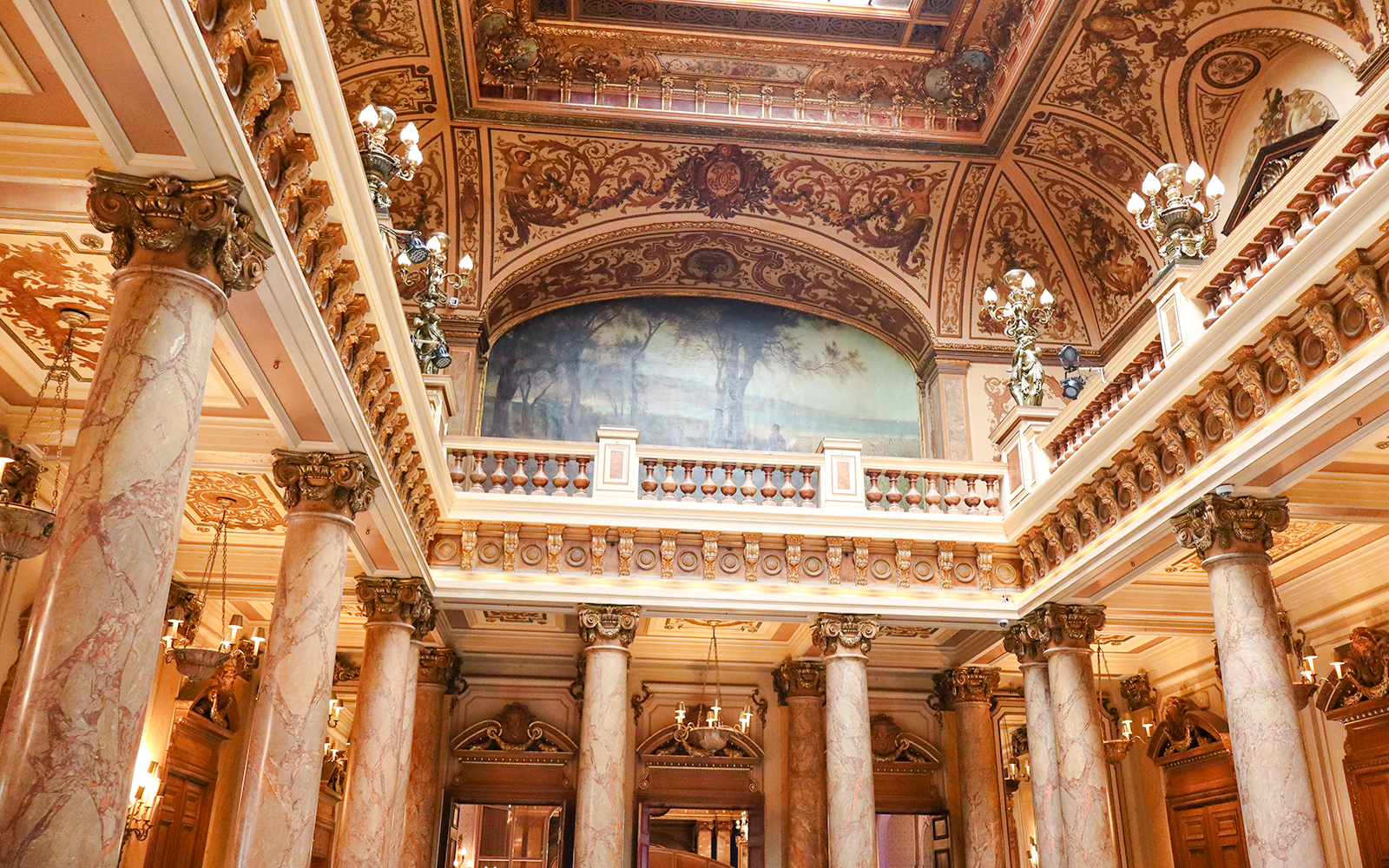Monte Carlo Casino interior with ornate ceiling and marble columns.