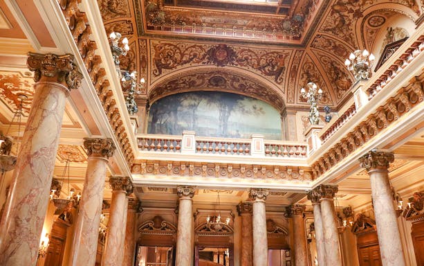 Monte Carlo Casino interior with ornate ceiling and marble columns.