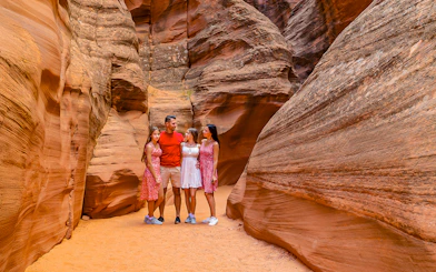 Group exploring Antelope Valley Canyon's sandstone formations on Ligai Si Anii Tour.
