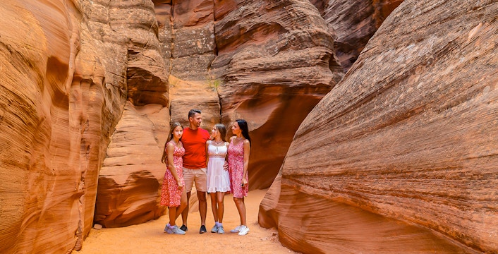 Group exploring Antelope Valley Canyon's sandstone formations on Ligai Si Anii Tour.