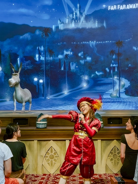 Donkey from Shrek interacts with audience during a stage performance in Far Far Away.
