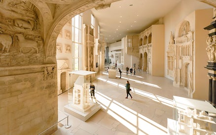 Notre-Dame de Paris exhibition hall with architectural models and sculptures.