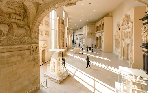 Notre-Dame de Paris exhibition hall with architectural models and sculptures.