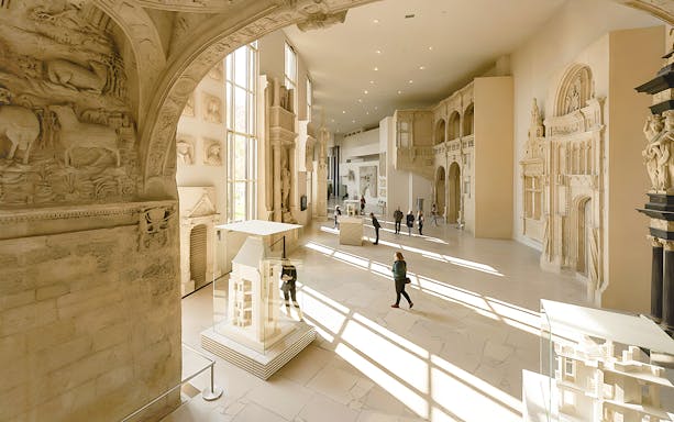 Notre-Dame de Paris exhibition hall with architectural models and sculptures.