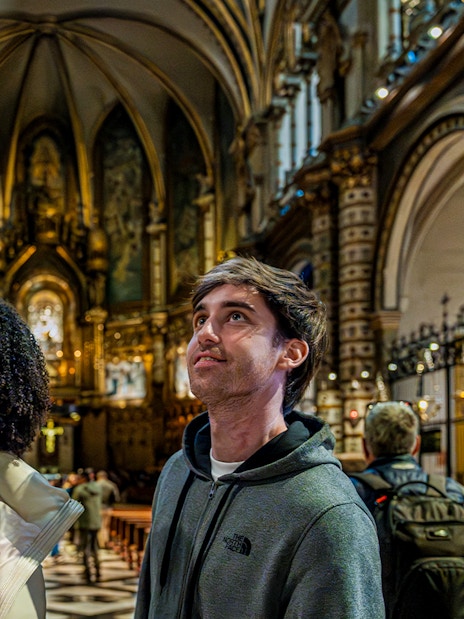Tourists admiring the interior of Montserrat Monastery, Spain.