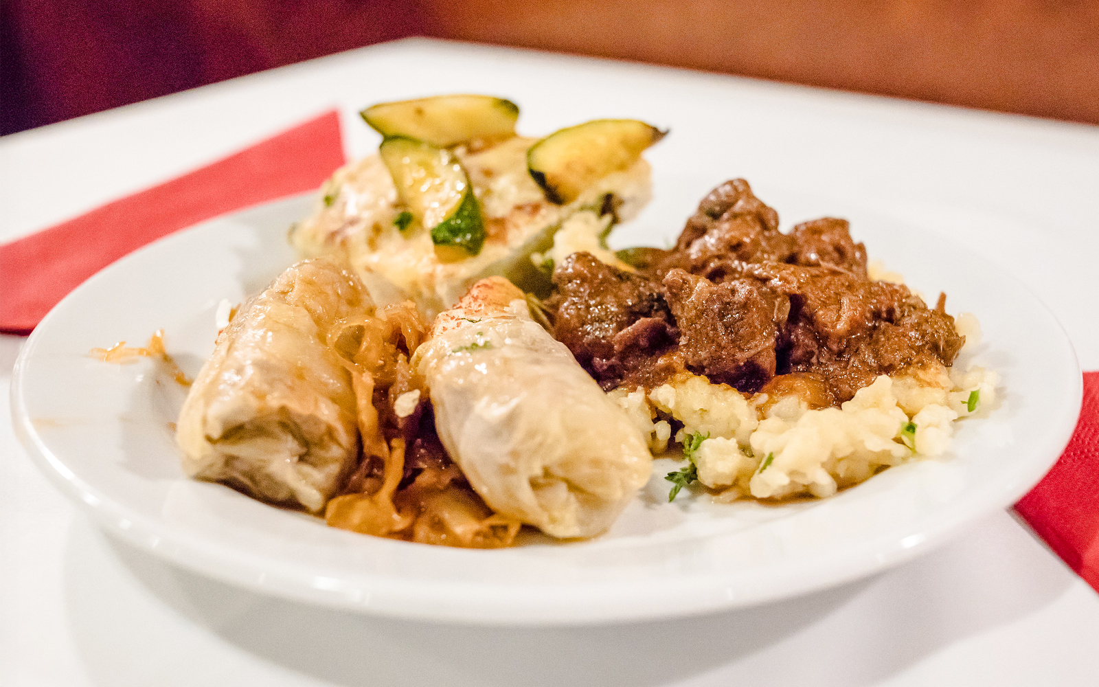 Traditional Hungarian dishes on a plate during a Danube dinner cruise buffet.
