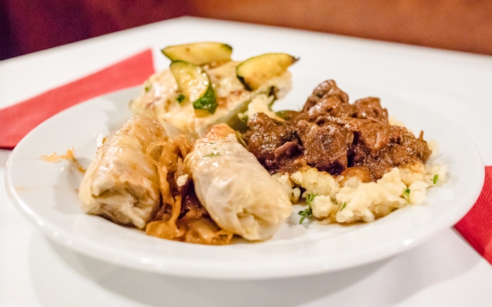 Traditional Hungarian dishes on a plate during a Danube dinner cruise buffet.