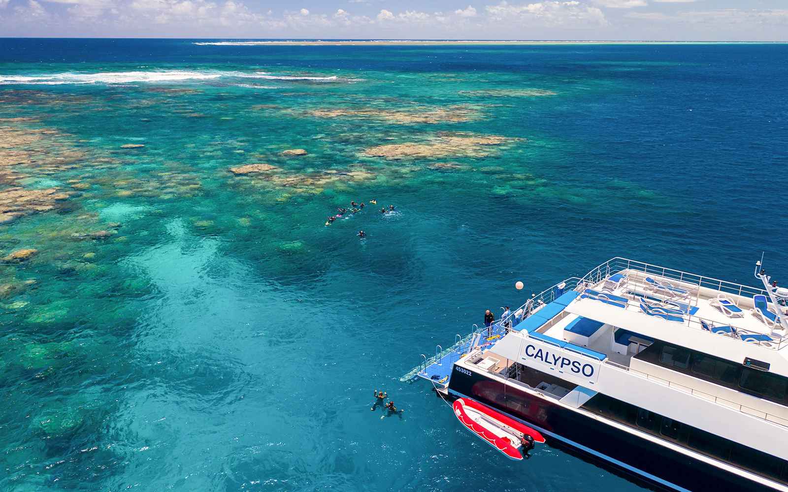 Cruise ship near snorkelers on the Outer Great Barrier Reef.