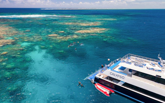 Cruise ship near snorkelers on the Outer Great Barrier Reef.
