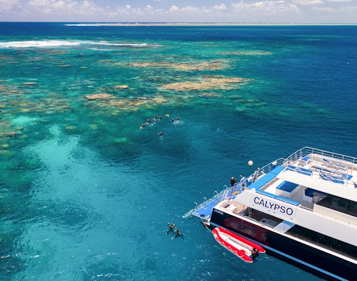 Cruise ship near snorkelers on the Outer Great Barrier Reef.