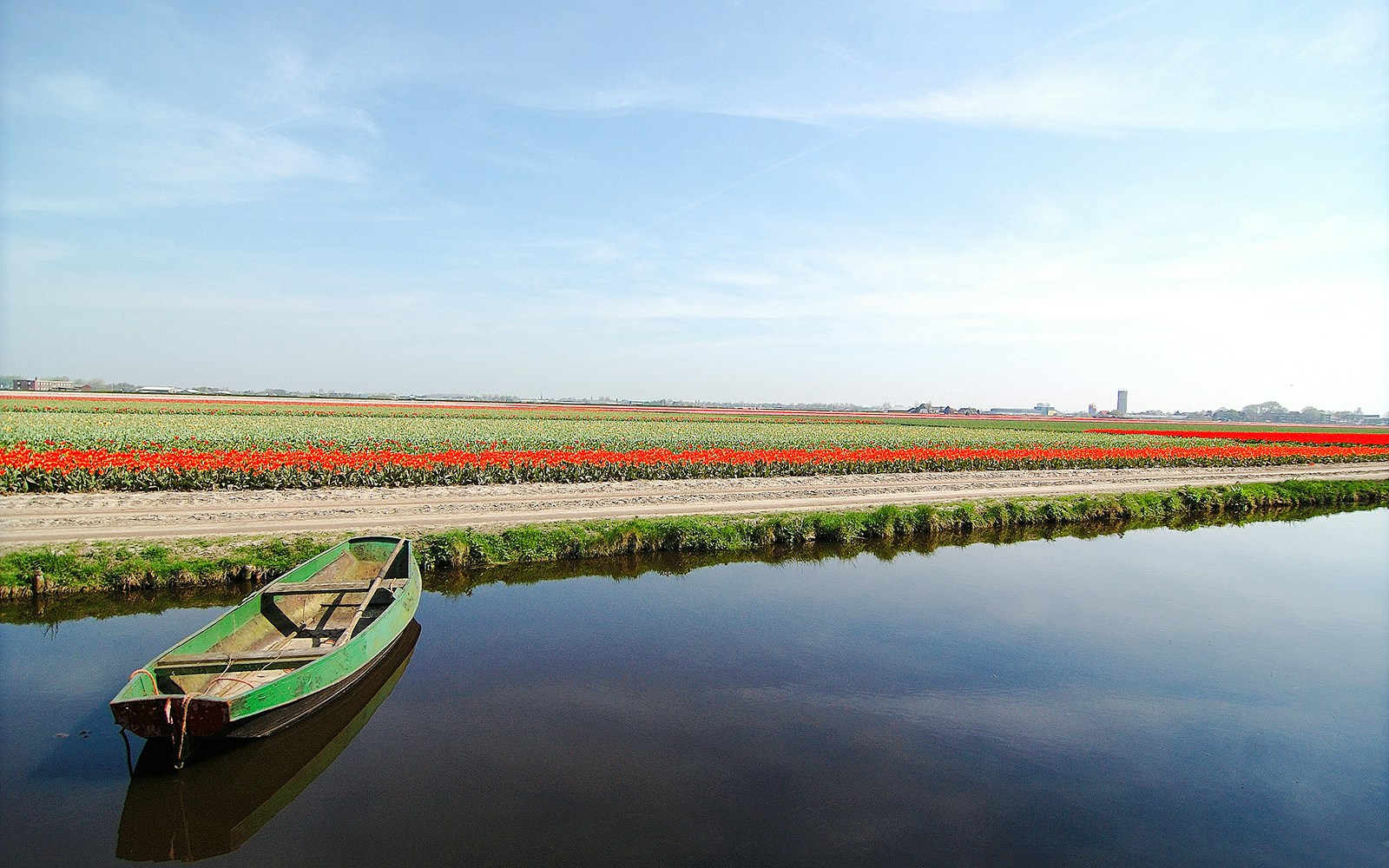 Whisper boat on canal with tulip fields at Keukenhof, Netherlands.