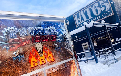 Frozen Smoke BBQ truck outside Lat65 Brewing Co. in snowy Fairbanks.