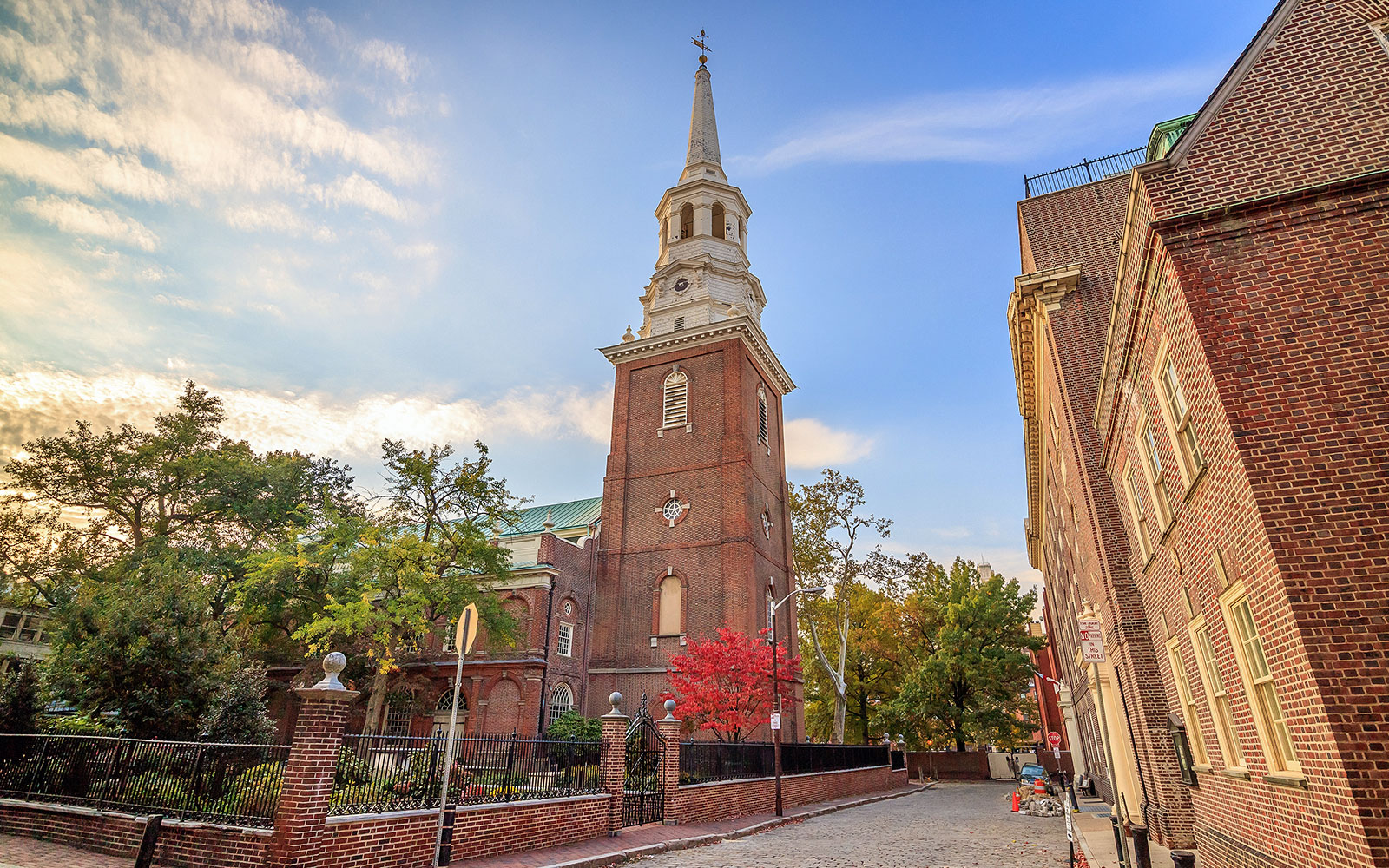 Christ Church in Philadelphia with its historic brick tower and surrounding trees.