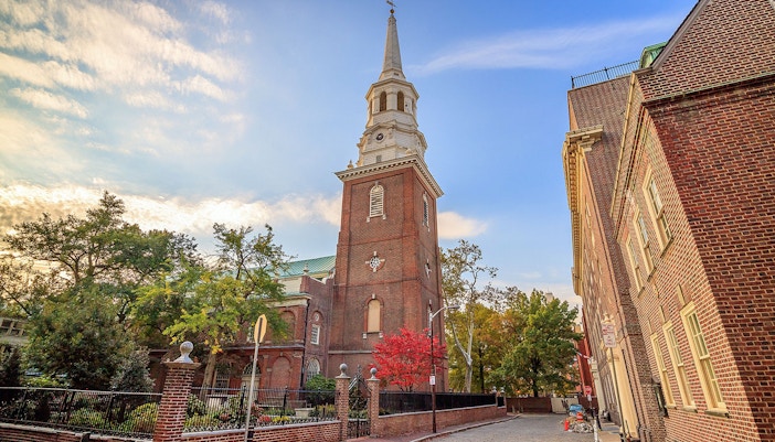 Christ Church in Philadelphia with its historic brick tower and surrounding trees.
