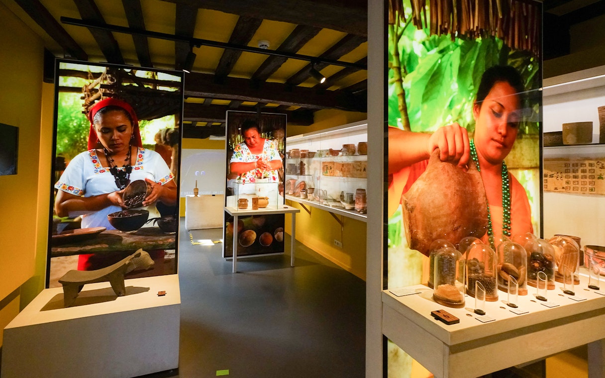 Tourists exploring chocolate exhibits at Choco Story museum in Brussels.
