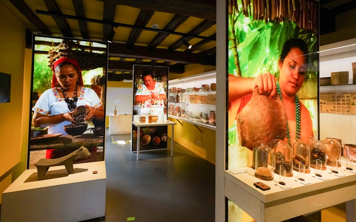 Tourists exploring chocolate exhibits at Choco Story museum in Brussels.