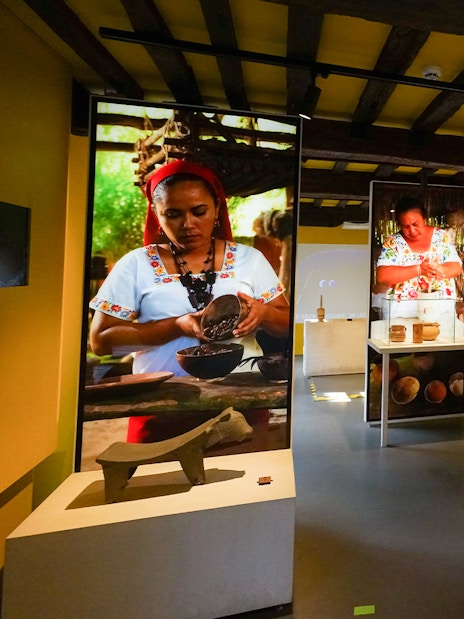 Tourists exploring chocolate exhibits at Choco Story museum in Brussels.