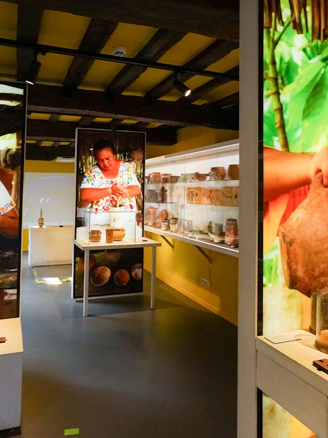 Tourists exploring chocolate exhibits at Choco Story museum in Brussels.