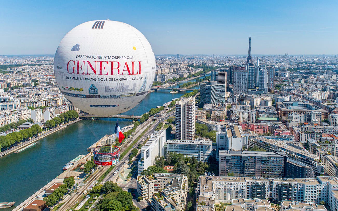 Ballon de Paris Generali floating over Paris with Eiffel Tower in the background.