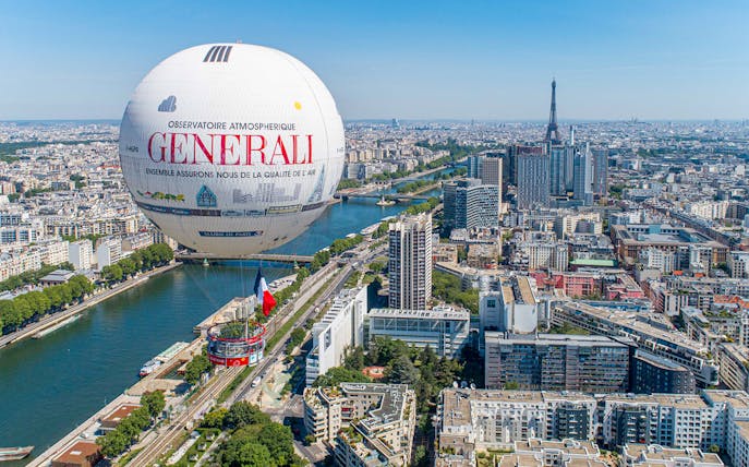 Ballon de Paris Generali floating over Paris with Eiffel Tower in the background.