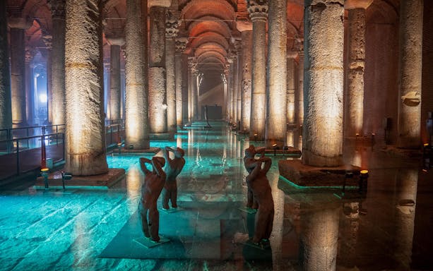 Statues and columns inside the illuminated Basilica Cistern, Istanbul.