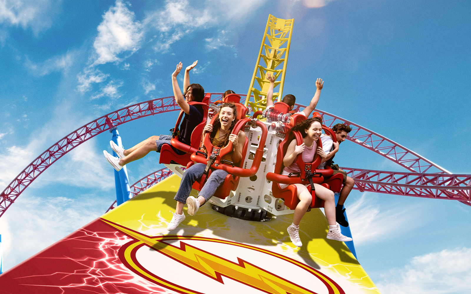 Tourists enjoying the Flash ride at Movie World with vibrant roller coaster tracks.