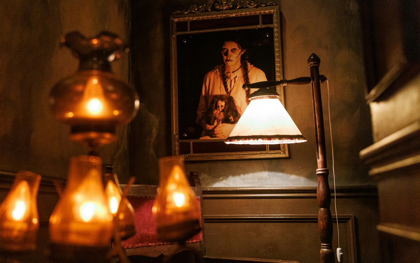 Dimly lit room with eerie portrait at Hotel 666, Tibidabo Amusement Park.