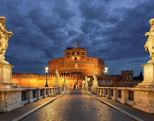 Castel St Angelo illuminated at night during Rome open bus city tour.