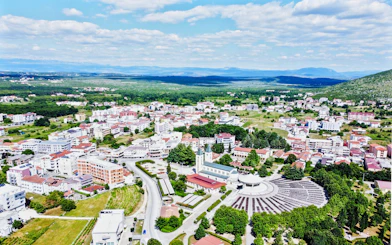 Aerial view of Međugorje, Bosnia and Herzegovina, featuring St. James Church and surrounding landscape.