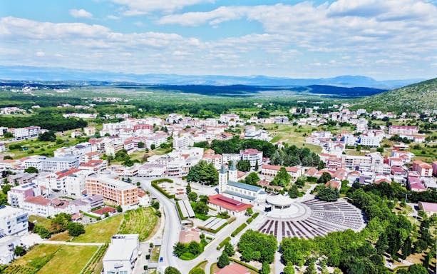 Aerial view of Međugorje, Bosnia and Herzegovina, featuring St. James Church and surrounding landscape.