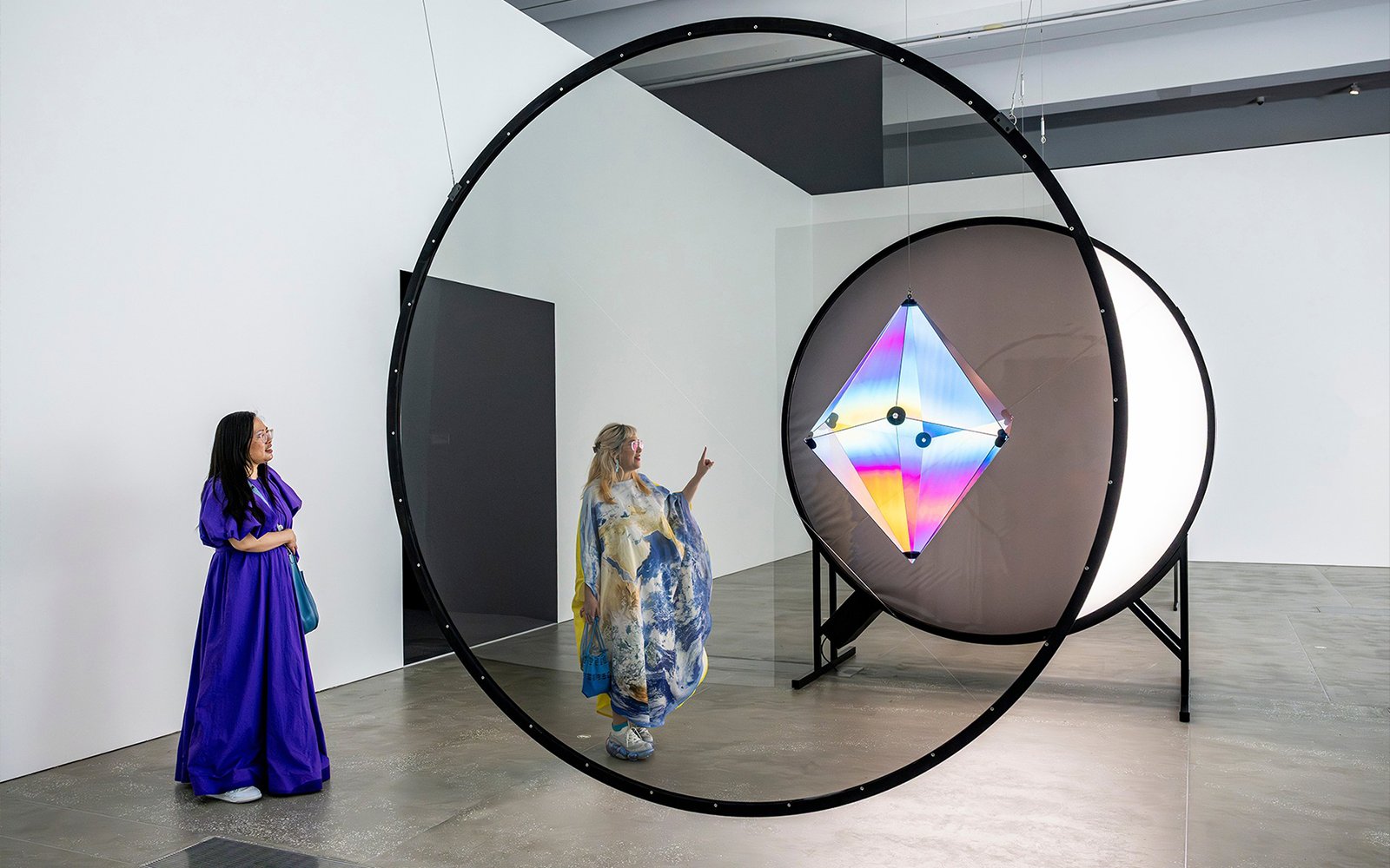 Visitors observing Olafur Eliasson's light installation at Gallery of Modern Art.