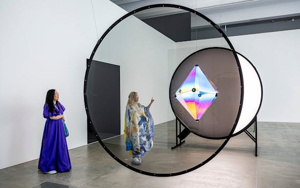Visitors observing Olafur Eliasson's light installation at Gallery of Modern Art.