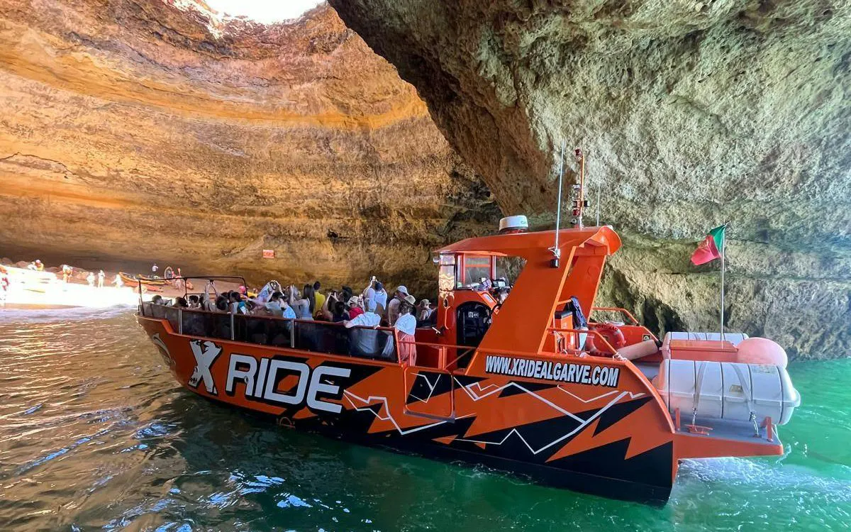 Tourists on a boat tour inside Benagil Caves, Algarve.
