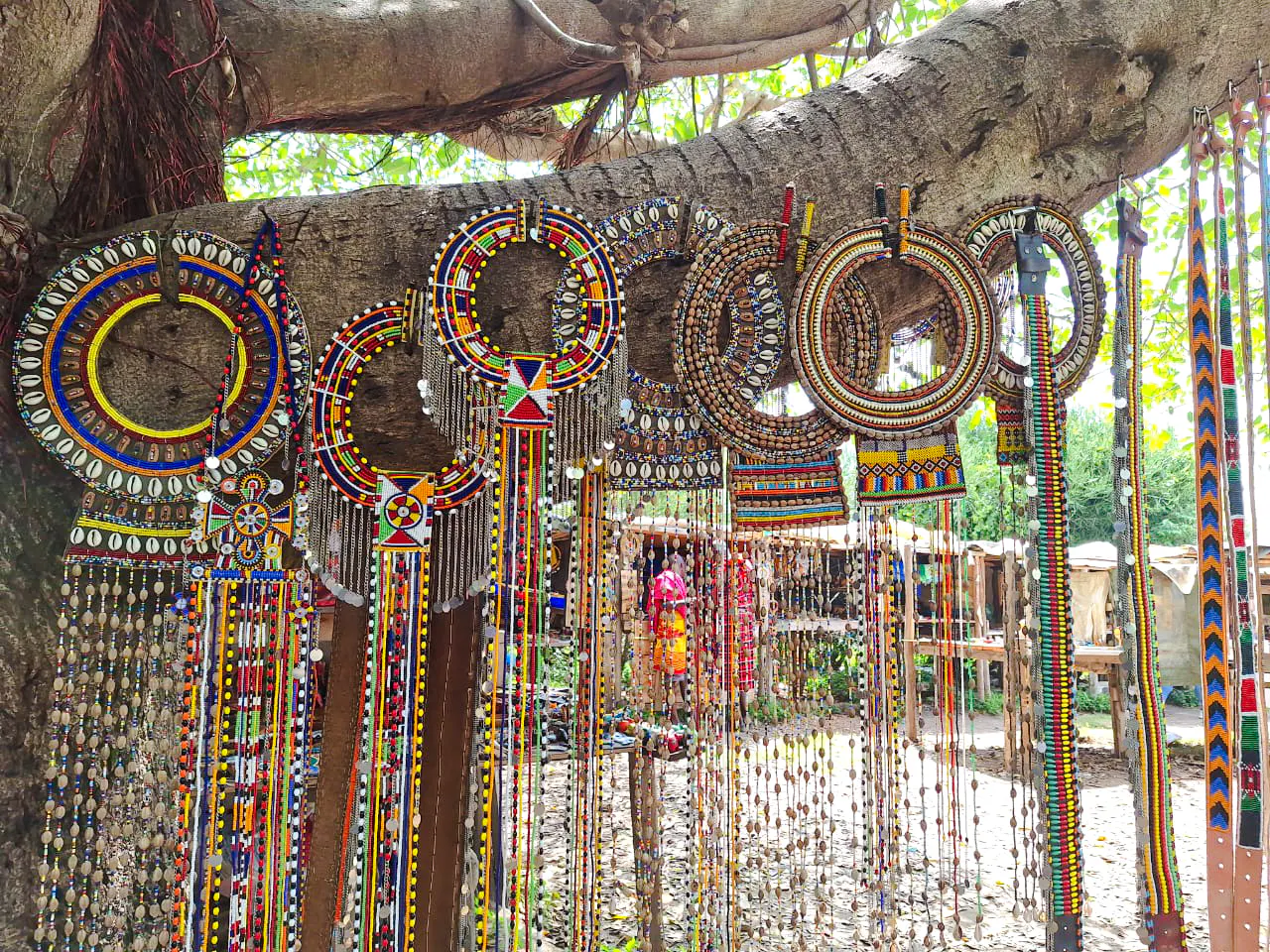 Traditional Maasai beadwork displayed on a tree during Nairobi city tour.