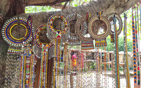 Traditional Maasai beadwork displayed on a tree during Nairobi city tour.