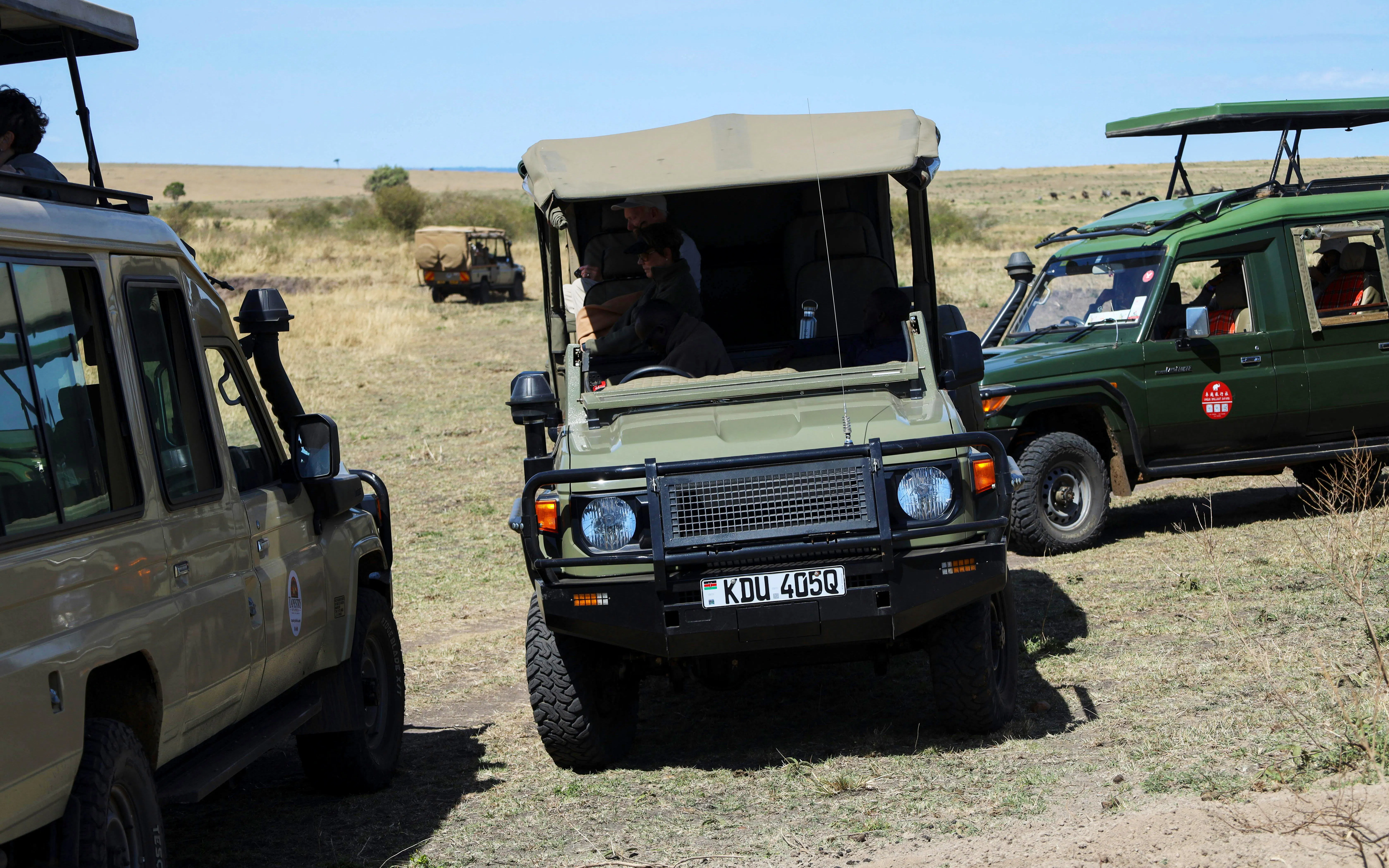 Safari jeeps on a tour in Masai Mara, Kenya.