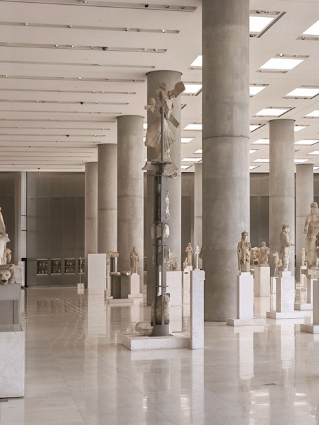 Ancient sculptures in the Athens Acropolis Museum exhibit hall.
