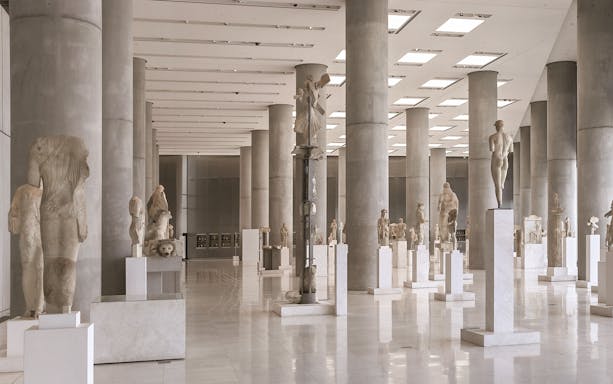 Ancient sculptures in the Athens Acropolis Museum exhibit hall.