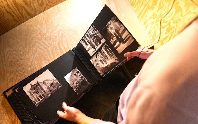 Photo album with historical images at Oskar Schindler's Factory entrance.