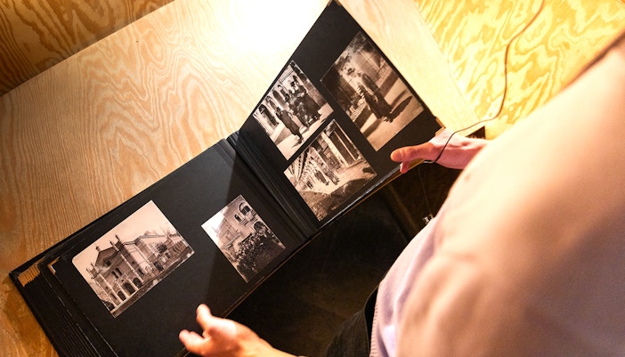 Photo album with historical images at Oskar Schindler's Factory entrance.