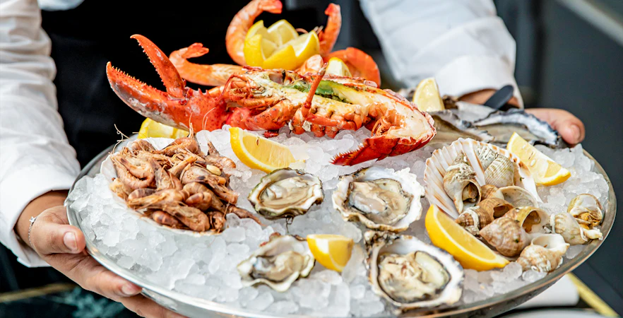Seafood platter with lobster, oysters, shrimp, and lemon at Brasserie Rosalie.