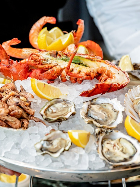 Seafood platter with lobster, oysters, shrimp, and lemon at Brasserie Rosalie.