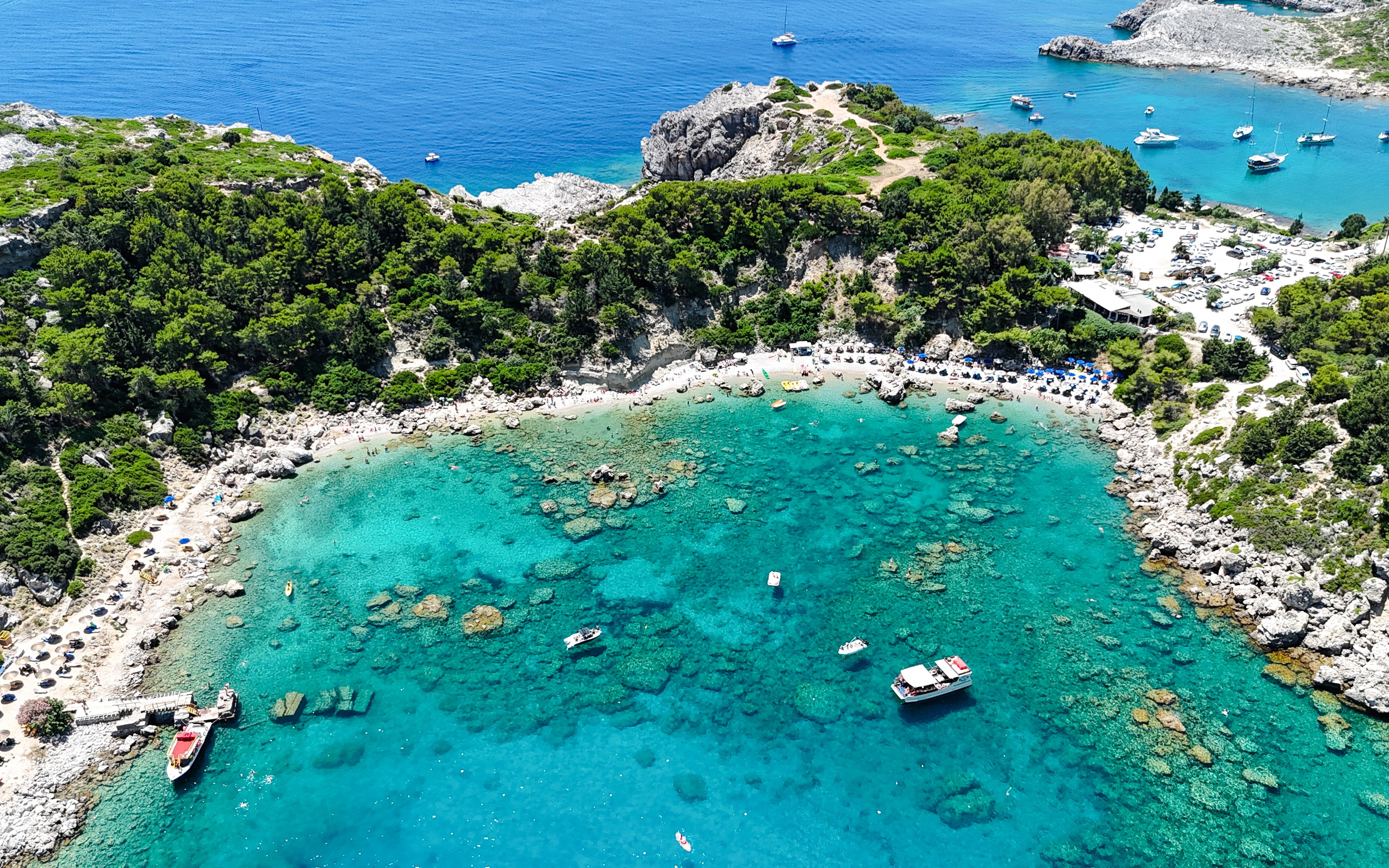 Aerial view of Anthony Quinn Bay with turquoise waters and boats, Rhodes, Greece.