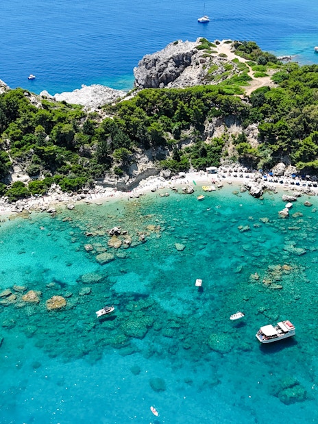 Aerial view of Anthony Quinn Bay with turquoise waters and boats, Rhodes, Greece.