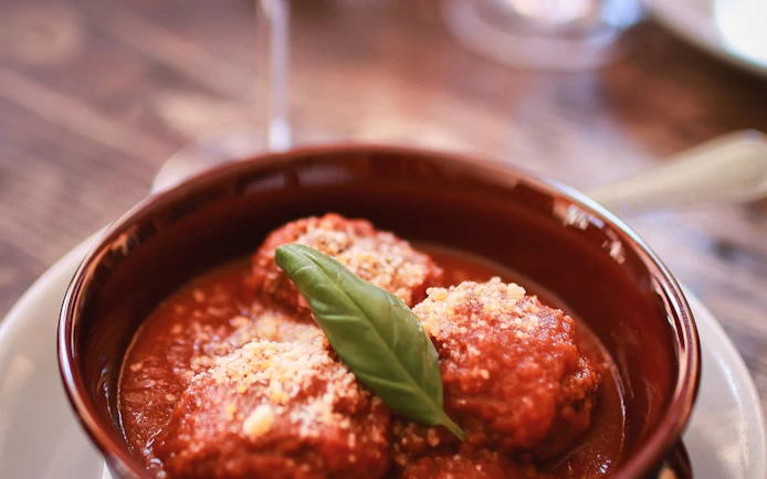 Meatballs in tomato sauce with basil, part of Verona's Romeo & Juliet food tour.